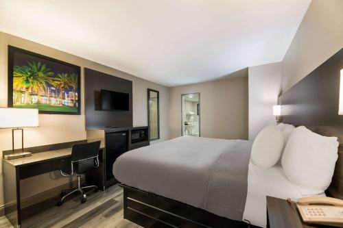 a hotel room with a bed and a desk and a computer at Quality Inn & Suites Altamonte Springs Orlando-North in Orlando