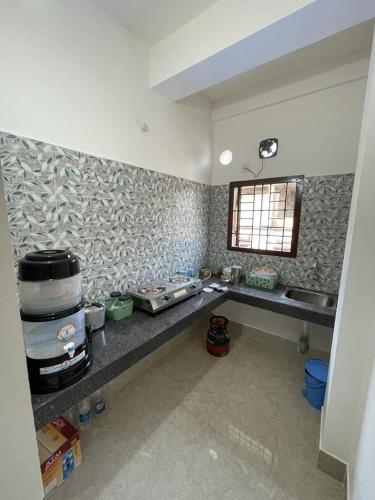a kitchen with a counter and a sink in it at Hrishi’s home in Guwahati