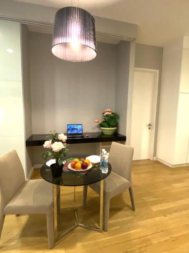 a dining room with a table with a bowl of fruit on it at KLCC Sky Villa Suites Platinum in Kuala Lumpur