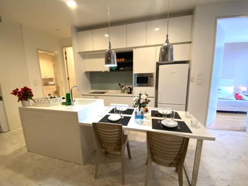 a kitchen with a table and chairs in a kitchen at KLCC Sky Villa Suites Platinum in Kuala Lumpur