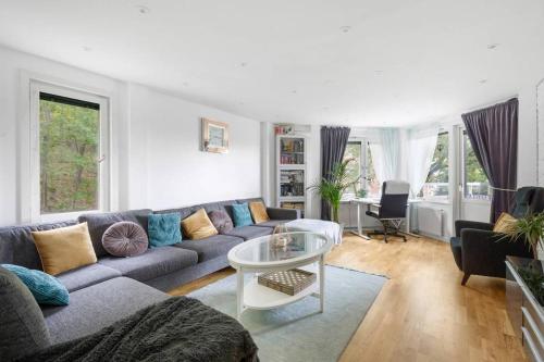 a living room with a couch and a table at Alby flexible checkin in Stockholm