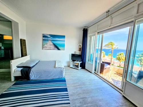 a bedroom with a bed and a view of the ocean at Promenade Sea Front in Nice