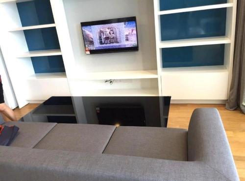 a living room with a couch and a flat screen tv at KLCC Sky Villa Suites Platinum in Kuala Lumpur