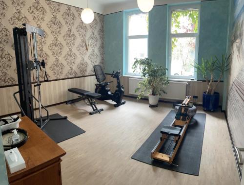 a room with exercise equipment and a room with a gym at Hotel Haus Martens in Hannover