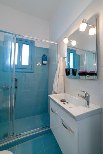 a bathroom with a sink and a shower at Adelphi Apartments in Perissa