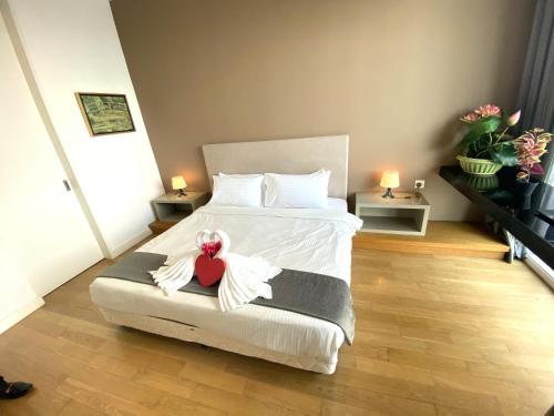a bedroom with a bed with a red heart on it at KLCC Sky Villa Suites Platinum in Kuala Lumpur