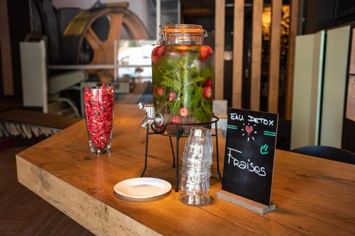 a jar filled with fruit and vegetables on a table at Ibis Alès Centre Ville in Alès