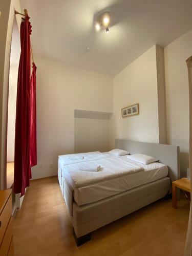 a bedroom with a bed and a red flag on the wall at Apartmány Poustevník Resort in Pec pod Sněžkou