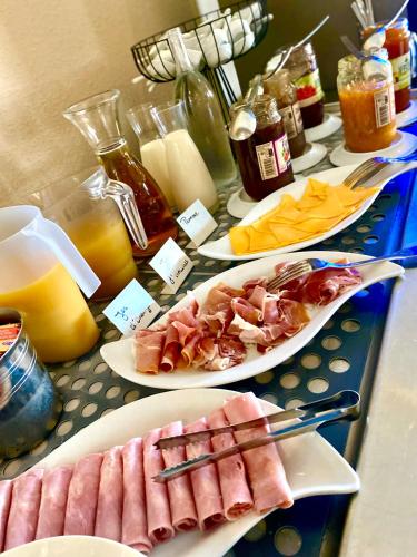 a table with plates of food on a table at Bella Vista Hôtel, Suites & Maisons in Porticcio