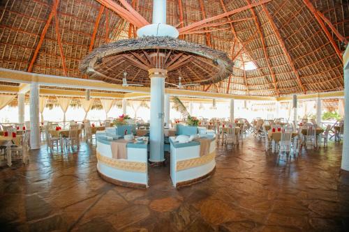 a large room with tables and chairs and a large ceiling at Twiga Beach Resort in Watamu