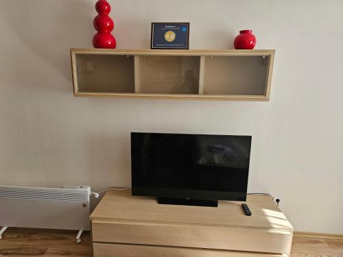 a living room with a flat screen tv on a table at Apartment in Borovets Gardens C17 in Borovets