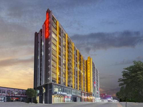 a large building with a red sign on it at LanOu Hotel Xuchang Caowei Ancient City in Xuchang