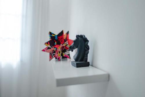 a statue sitting on a white table in a room at The Kilimanjaro Villa in Moshi