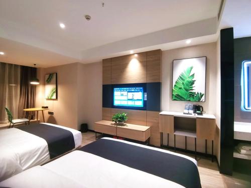 Thank Inn Plus Chongqing Pengshui Yujing Jiangshan في Pengshui: غرفه فندقيه سريرين وتلفزيون