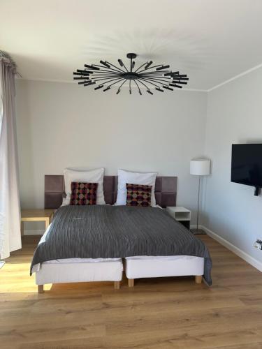 a bedroom with a large black clock on the wall at Apartament Hebanowa in Swarzędz