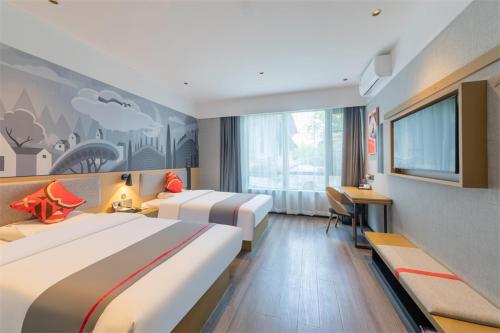 a hotel room with two beds and a flat screen tv at Thank Inn Shaoxing Luxun Hometown in Shaoxing