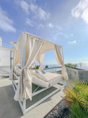 a bed on the roof of a house at Casa el Goce - Luxury Villa, private pool, BBQ and bathtub in Tijarafe