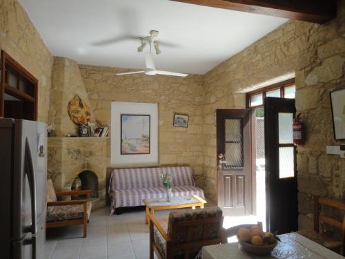 a living room with a couch and a fireplace at Spanos House in Goudhi