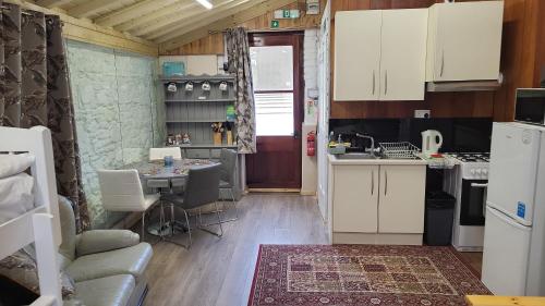 a kitchen with white cabinets and a table at Mount Pleasant Country House in Lucan