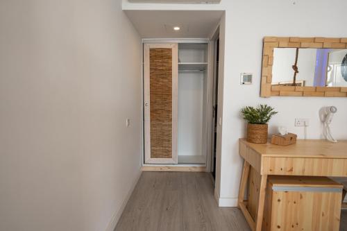 a room with a hallway with a door and a table at Blue Harbour Boutique in Ayia Napa