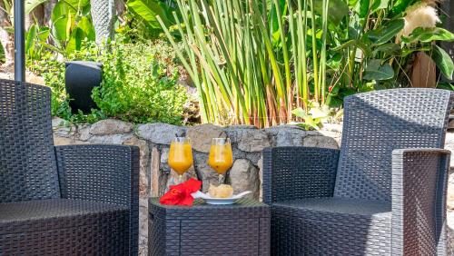 two glasses of orange juice sitting on wicker chairs at Bobby Executive in Sanremo