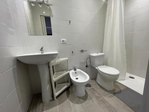 a white bathroom with a sink and a toilet at B&b paraiso tenerife in Los Abrigos