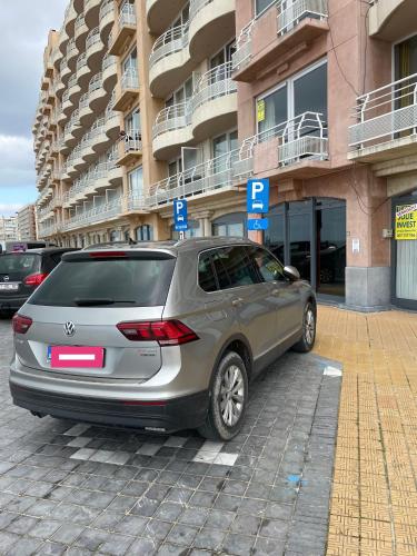 a silver car parked in front of a building at Vakantieverblijf Monopole Oostende in Ostend