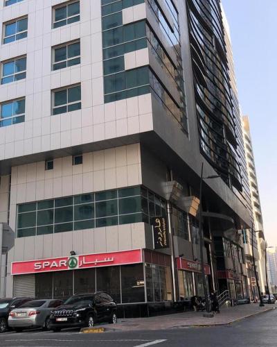 a large building with cars parked in front of it at SN Realestate Resedent in Abu Dhabi