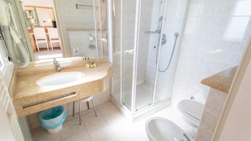 a bathroom with a shower and a sink and a toilet at Bobby Executive in Sanremo