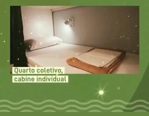 a small room with a bed in a room with avertisement at GVR Praia Hostel in João Pessoa