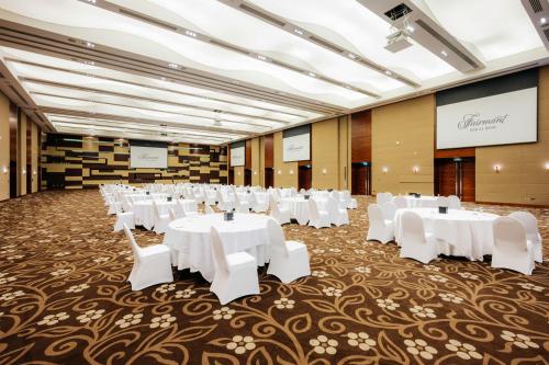 a banquet hall with white tables and white chairs at Fairmont Bab Al Bahr in Abu Dhabi