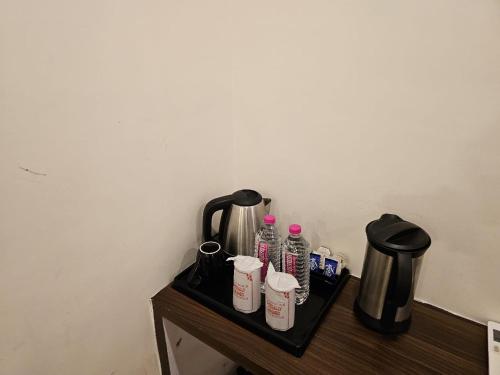 a table with bottles of water and a coffee pot at HOTEL ORCHID in Lucknow