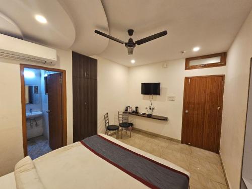 a bedroom with a bed with a ceiling fan at HOTEL ORCHID in Lucknow