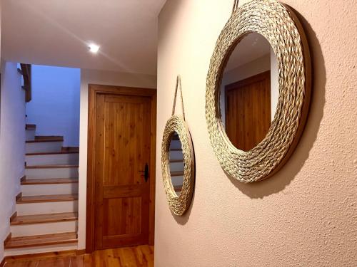 a pair of mirrors hanging on a wall next to a door at Apartamento Sol de Espot - L'Amfitriona in Espot
