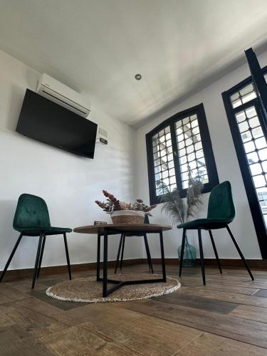 a living room with a table and two chairs at Hotel Rural Irina in Badajoz