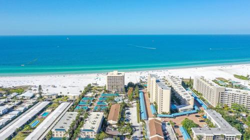 an aerial view of a beach with buildings and the ocean at Gulf side, spacious 1 bedroom, 1 bath, 200 steps to Crescent Beach in Siesta Key