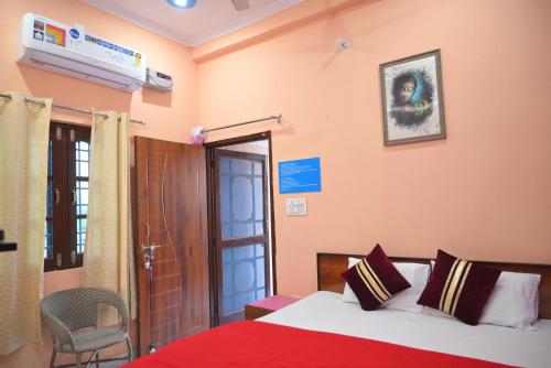 a hotel room with a bed and a window at Sakshi ganga in Birbhaddar