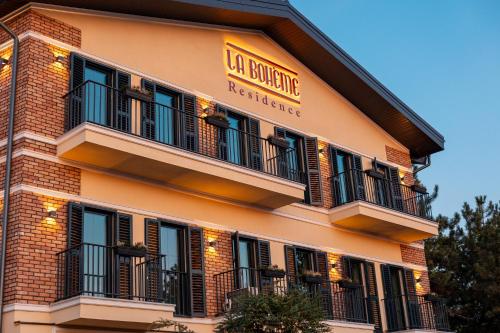a building with balconies on the side of it at La Boheme Corbeanca - partener Therme in Ostratu