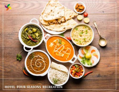 a table with different dishes of food on it at The Four Seasons Recreation in Jālgaon
