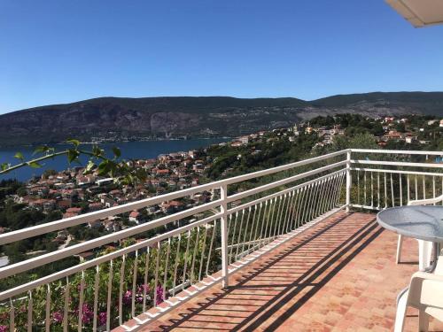 a balcony with a view of the water and buildings at Apartment Nelli in Herceg-Novi