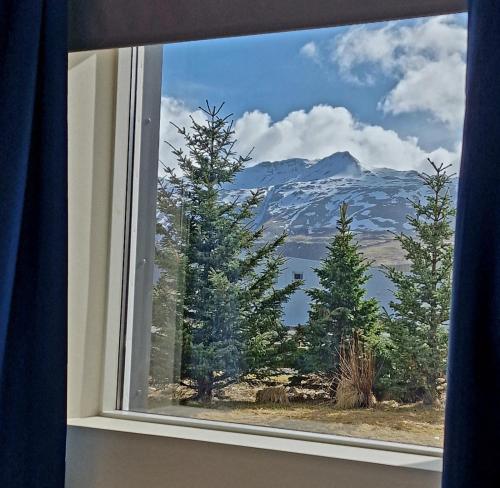 a window with a view of a mountain at Olga Apartments in Grundarfjordur