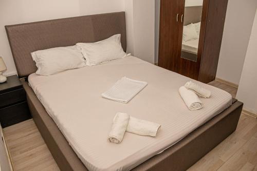 a bed with towels on it in a room at Occidental Wise Transit Hotel in Bucharest