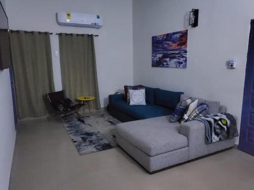 a living room with a couch and a table at Apartments for short stay in Ashalebotwe