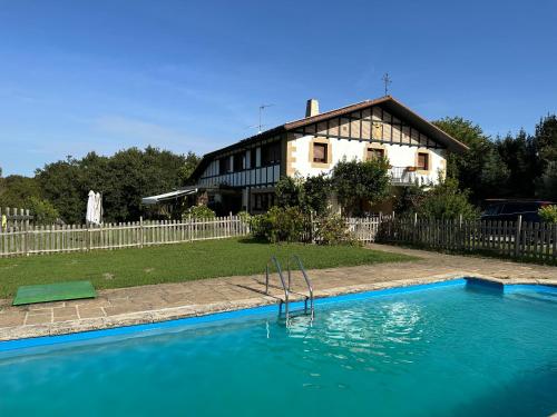 a large swimming pool in front of a house at Caserio Kamirune in Laukiz