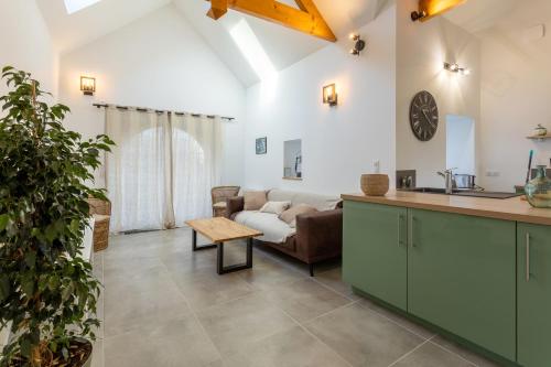 uma cozinha e sala de estar com um sofá e uma mesa em Gite plain-pied - 4 personnes em Landrévarzec