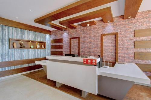 a room with a counter and a brick wall at Flagship Ooty Residency in Ooty