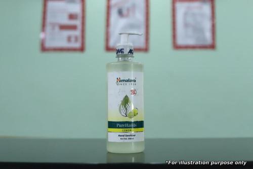 a bottle of moisturizing liquid sitting on a table at Ooty Residency in Ooty