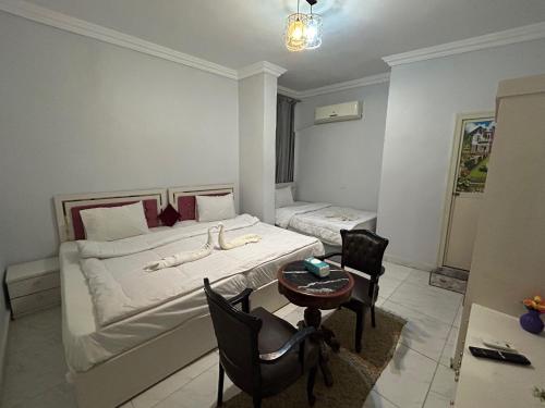 una camera da letto con un letto, un tavolo e delle sedie di Ahmose Pyramids view inn a Il Cairo