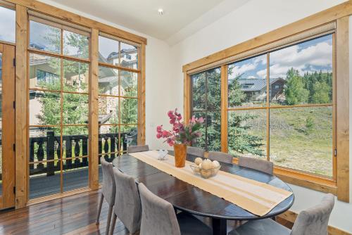 a dining room with a table and chairs and windows at Belvedere 4 townhouse in Telluride