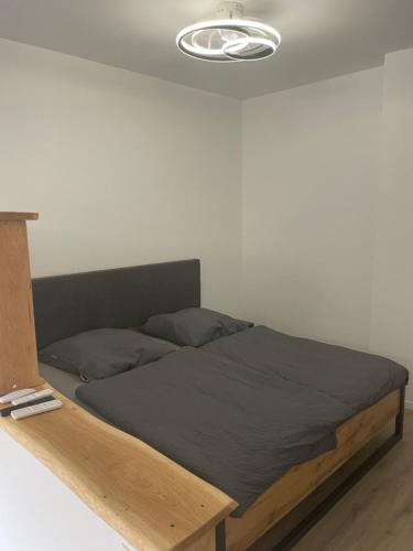 a bed with a wooden frame in a room at Appartment in Freizeitpark in Wiesloch